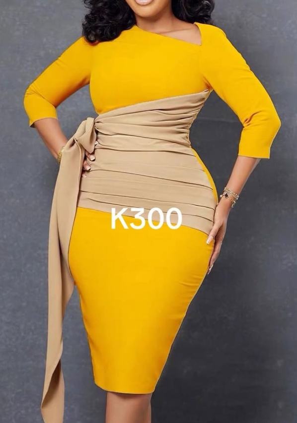 A yellow women's dress with an asymmetrical cut and a beige belt.