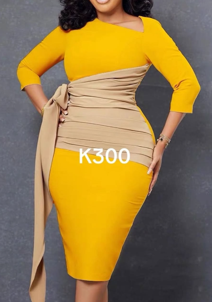 A yellow women's dress with an asymmetrical cut and a beige belt.