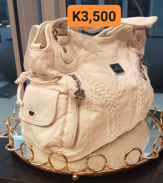 white leather bag with pockets