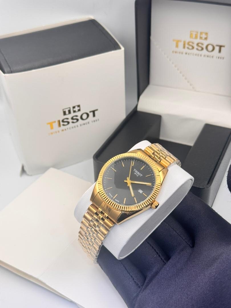 Montre Tissot en or avec bracelet métallique