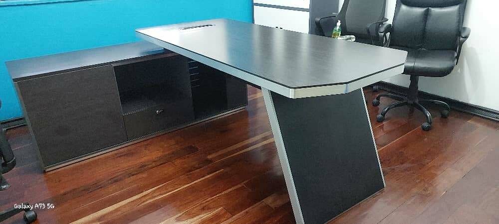 Executive table with a lockable safe using codes.