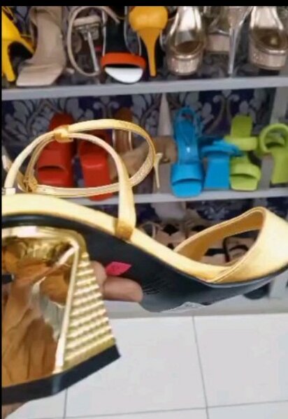 Golden sandals with an original heel