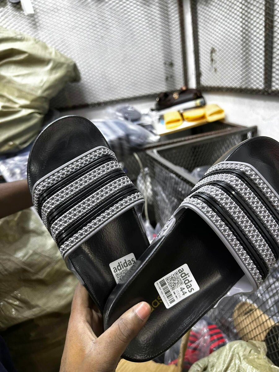 Men's black Adidas flip-flops with grey stripes, made of synthetic material