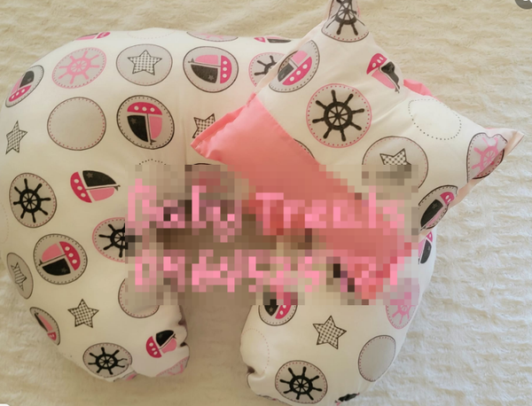 white-pink patterned feeding pillow