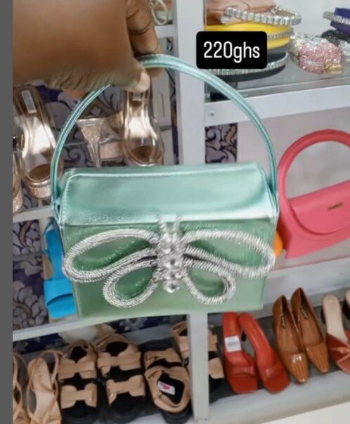 Green handbag with a rhinestone butterfly