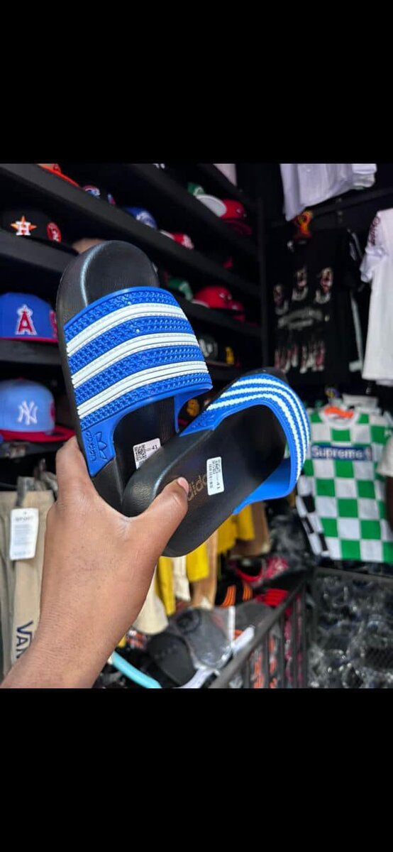 Men's blue Adidas flip-flops with white stripes, made of synthetic material
