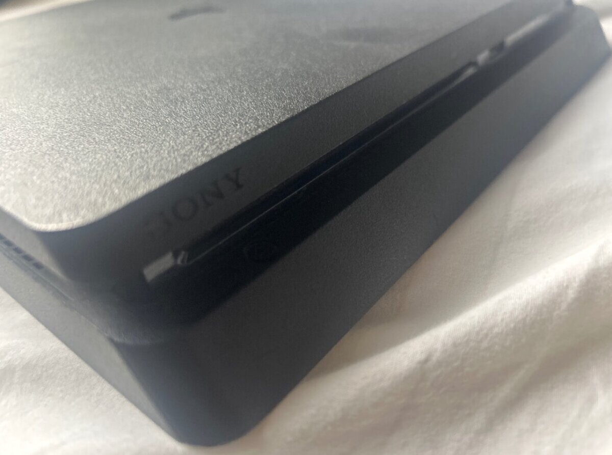 PlayStation 4 with controllers and games