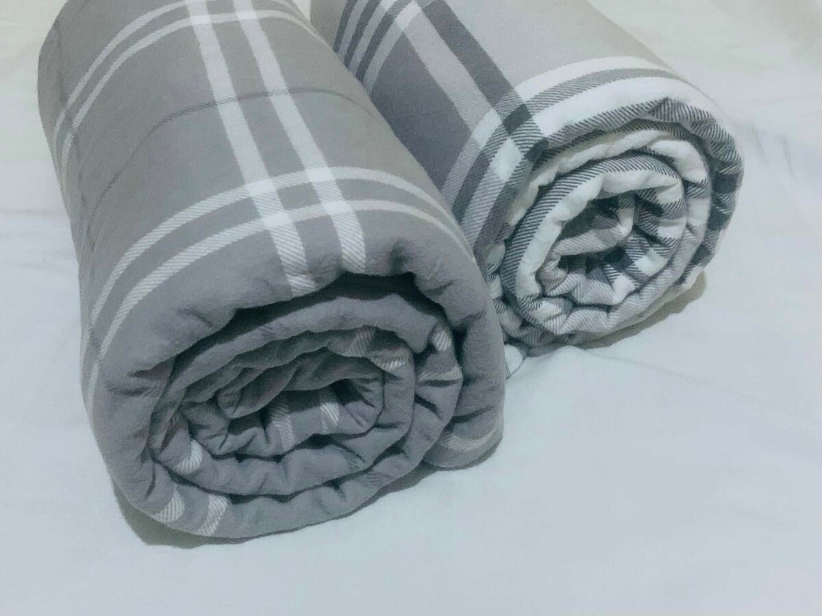 A set of grey plaid blankets