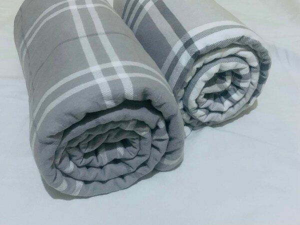 A set of grey plaid blankets