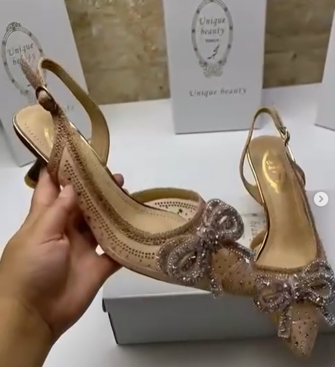 golden shoes with a bow