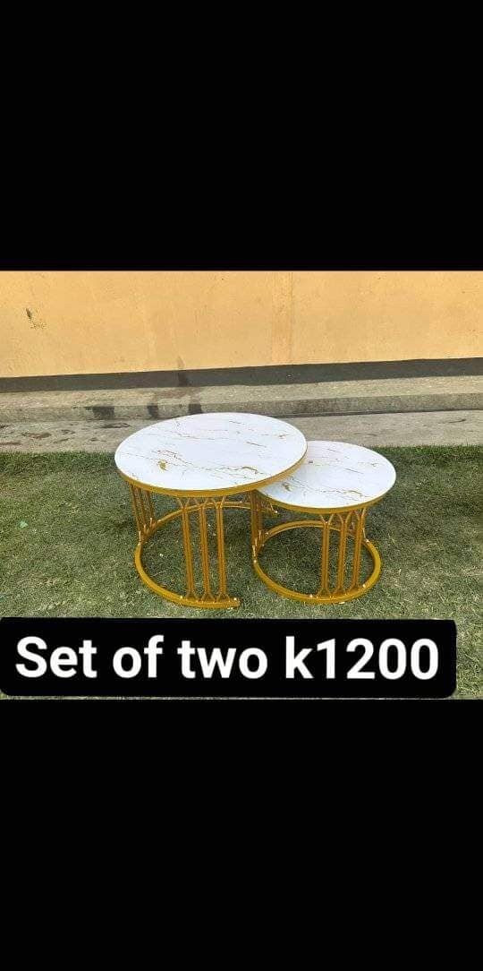 two white cabinets with golden legs