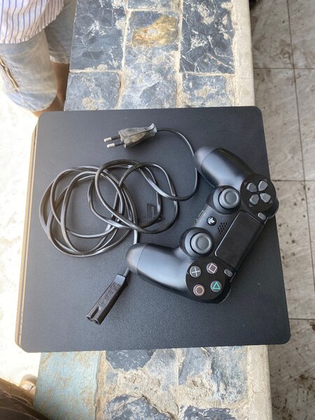 PS4 slim with one controller and FC 25 and 4 other games