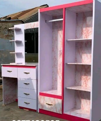 Pink and white wardrobe with dressing table and mirror