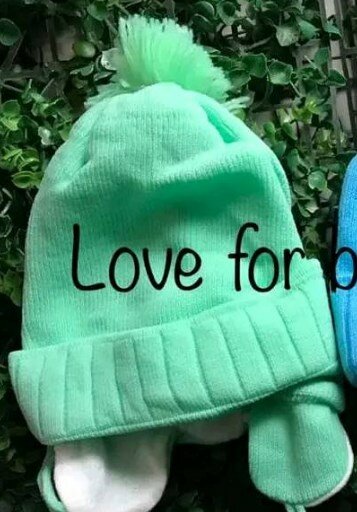 Beanie with ties and 1 pompom light green
