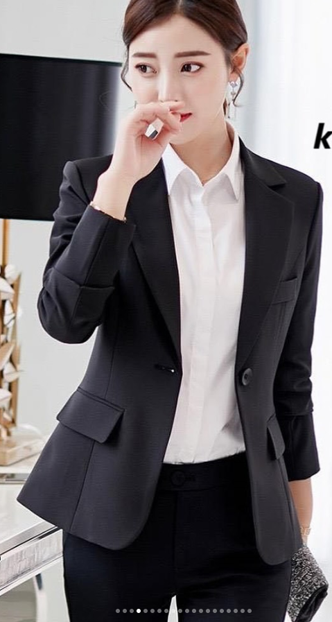 Women's suit with black jacket and white shirt.