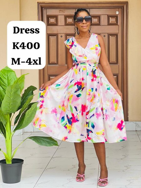 Women's dress is white with a print  M-4xl