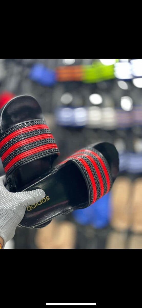 Men's black Adidas flip-flops with red stripes, made of synthetic material