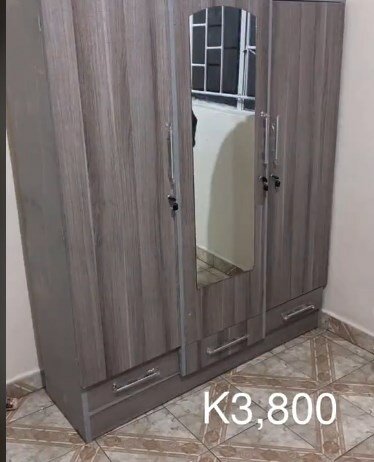 Gray wardrobe with drawers and mirror