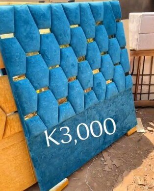 The headboard of the bed is soft and blue