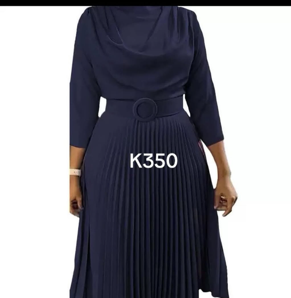 Women's dark blue dress with pleating and a belt with a ring.