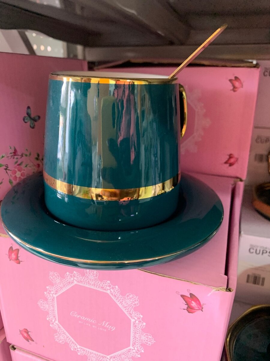 Colorful ceramic mug with saucer and spoon