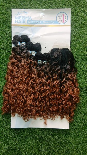 Extensions bouclés mèches marron