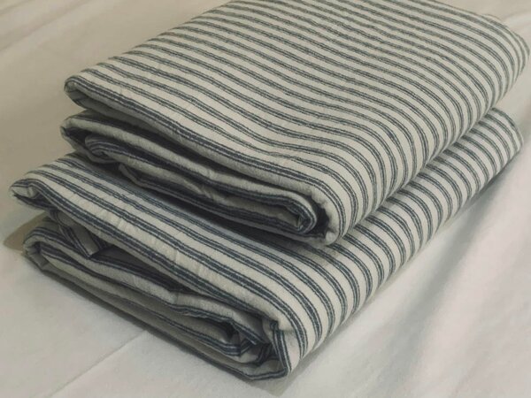 Grey striped bed linen.