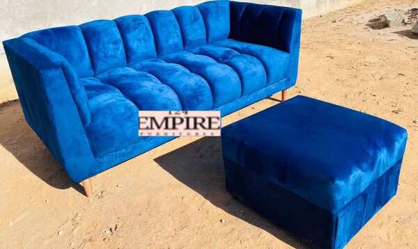 Sofa with blue upholstery and ottoman