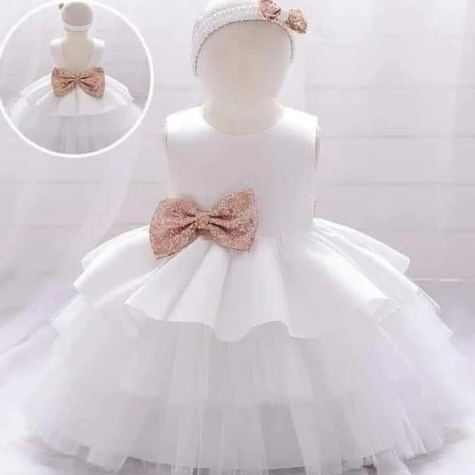 White dress with gold bow on the belt