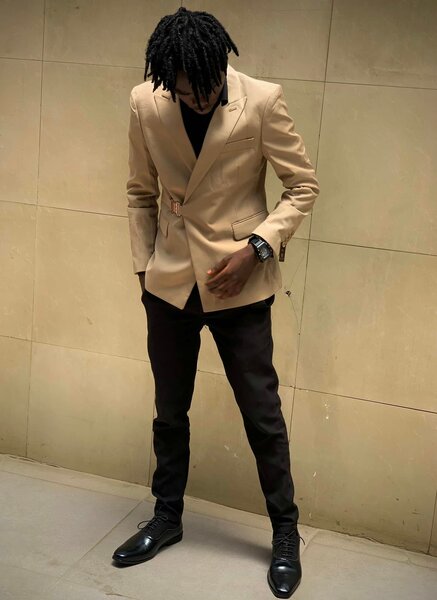 Suit with beige jacket and black trousers