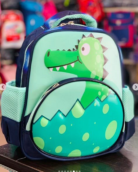 Blue-green backpack with a dinosaur