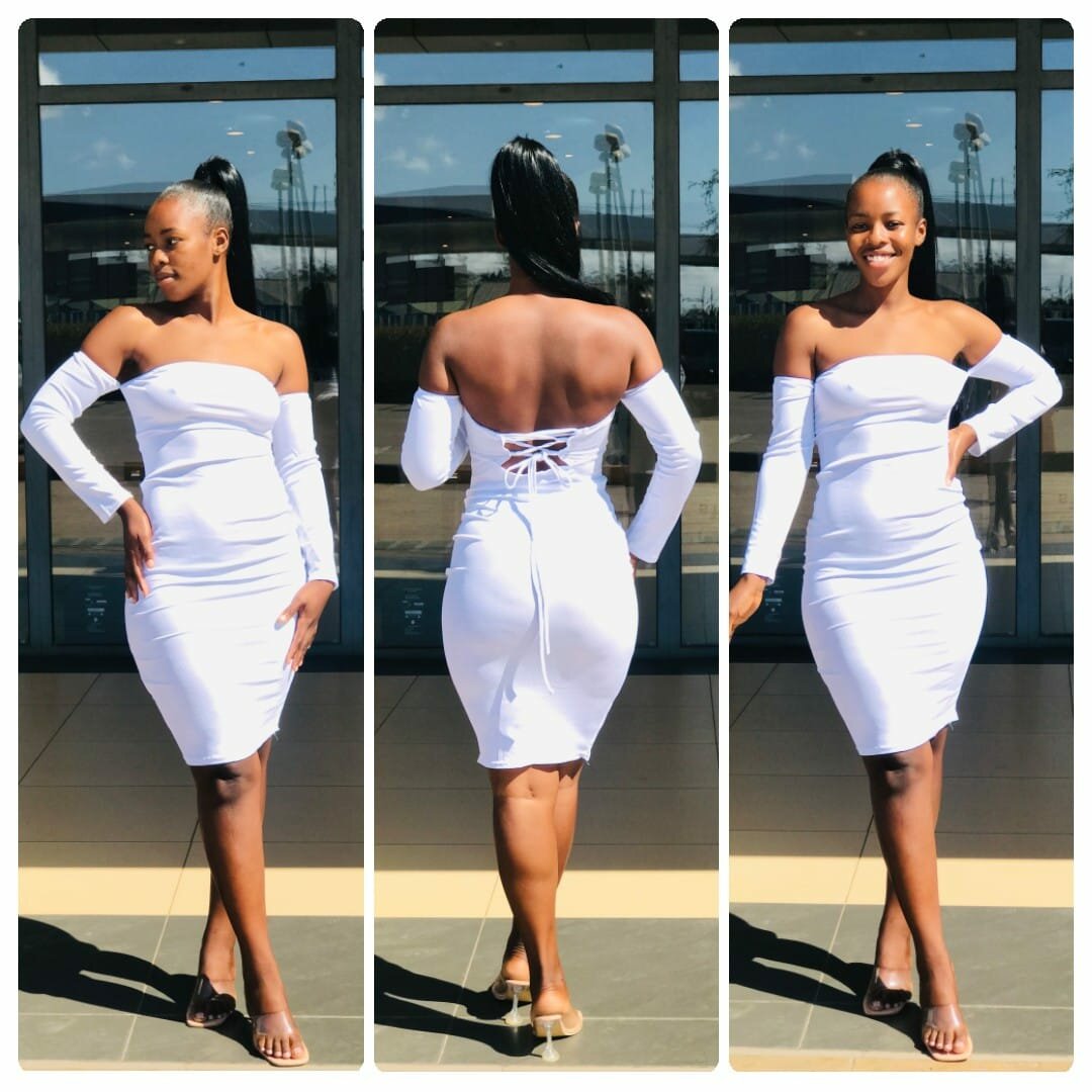 White fitted dress, open neckline, lacing on the back