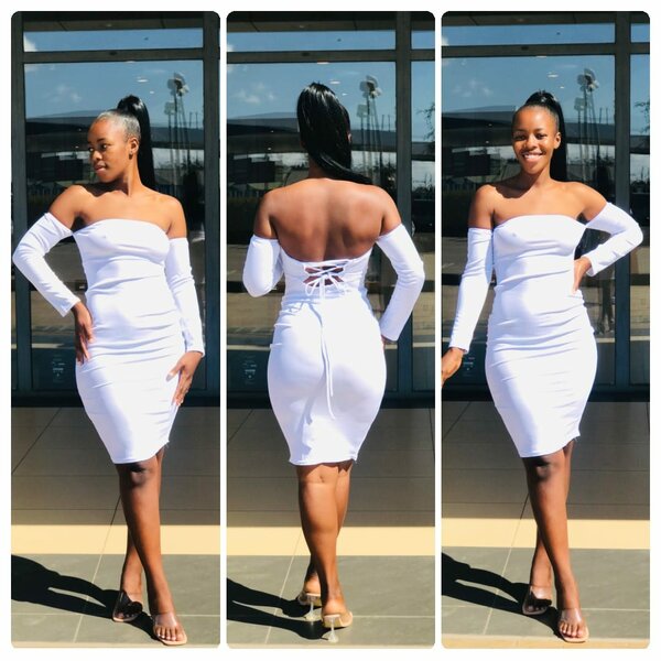 White fitted dress, open neckline, lacing on the back