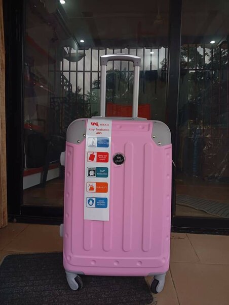 Valise rose à roulettes de voyage