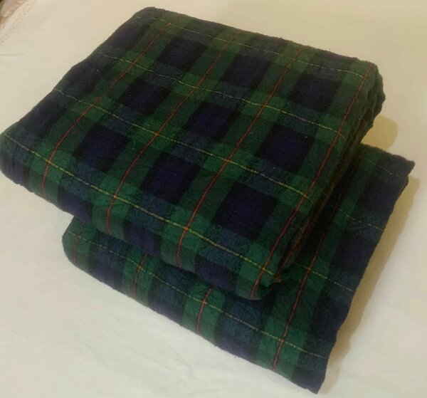 Dark green and dark blue checkered bed sheet with accent red and yellow lines