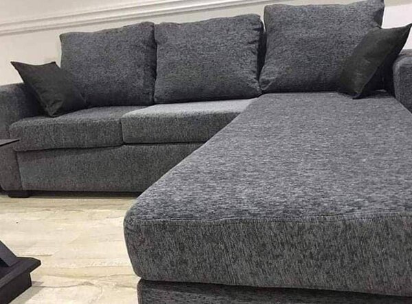 L-couch with throw pillows and footrest