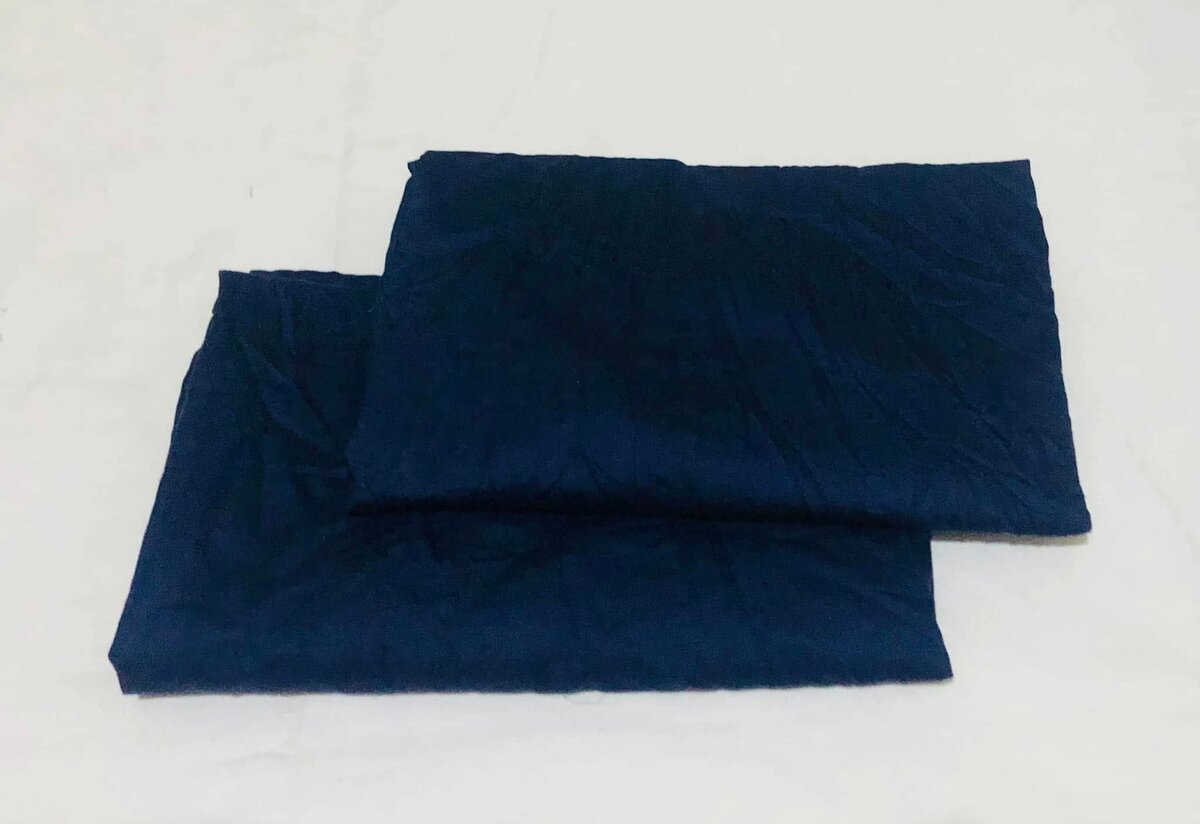 A set of dark blue fabric items,pillowcases or sheets.