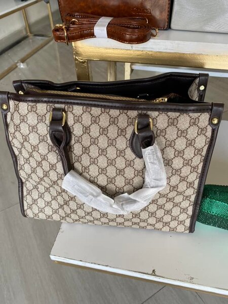 The bag is square in shape and brown in color