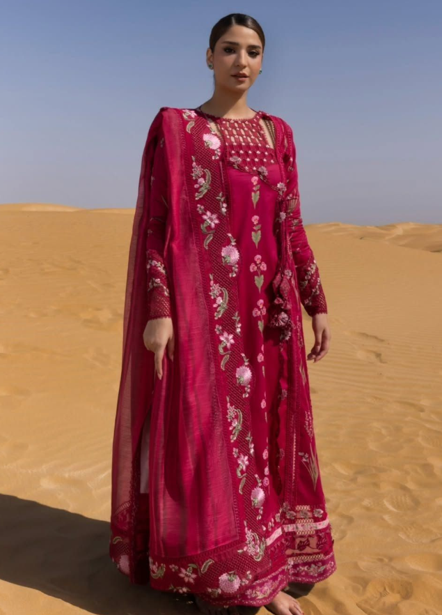 A luxurious dress in rich pink with delicate floral embroidery