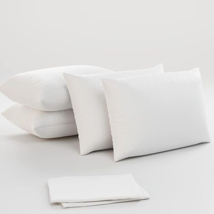 A set of white pillows with pillowcases.