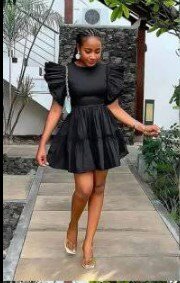 The dress is black, the sleeves and hem are multi-layered