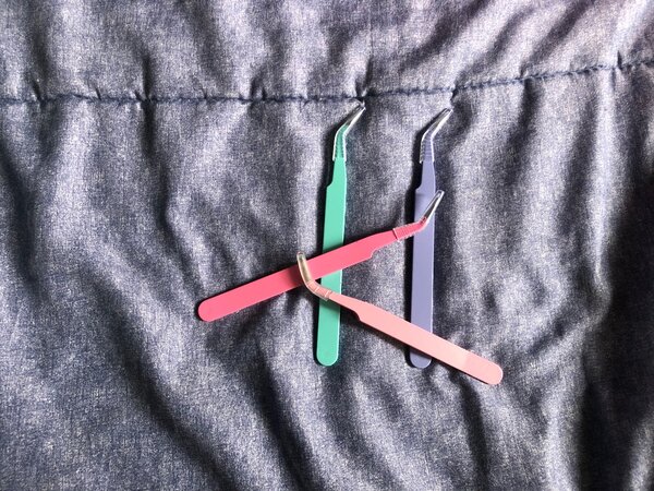 Lash and eyebrow tweezers each