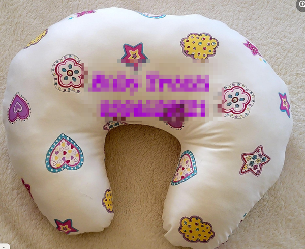 white patterned feeding pillow