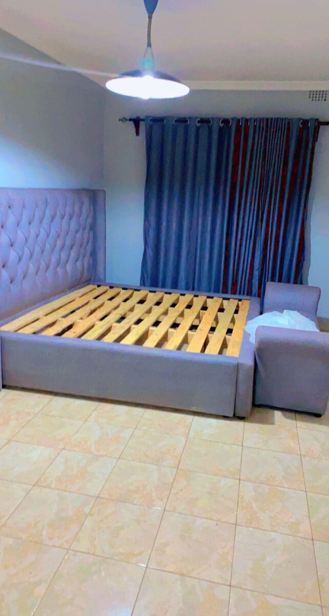 A bed with lilac upholstery