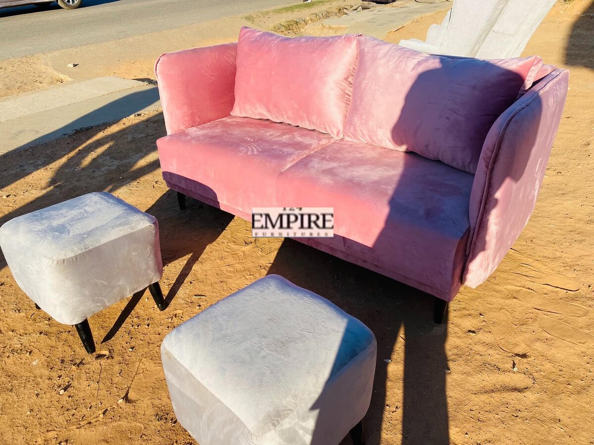 Sofa with pink upholstery and grey ottomans