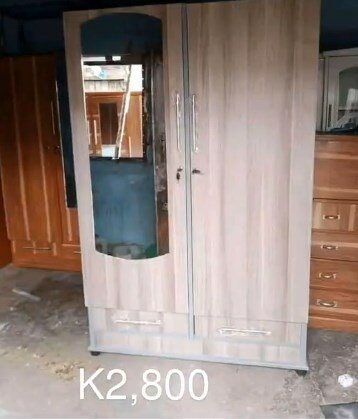 Light brown wardrobe with drawers and mirror