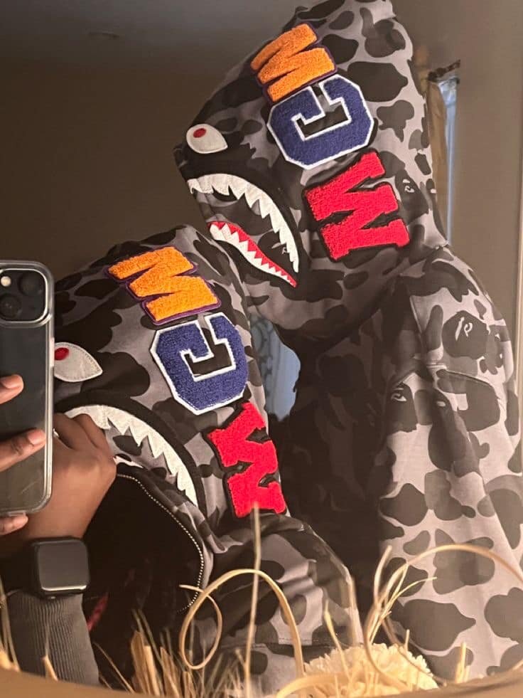 Grey hoodie with black camouflage print, shark-style hood and bright stripes, unisex