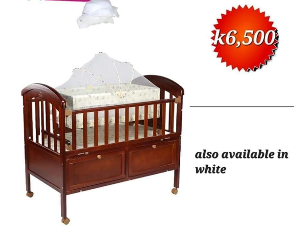 wooden crib with storage boxes