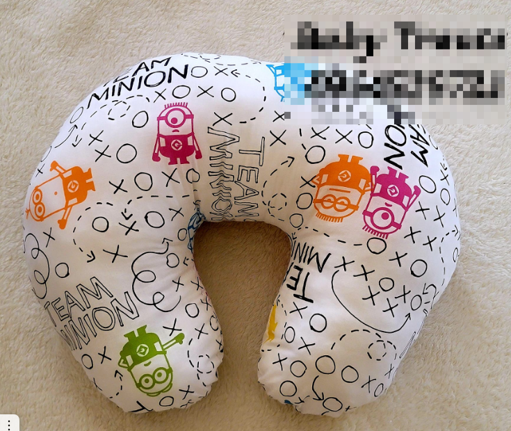 white patterned feeding pillow
