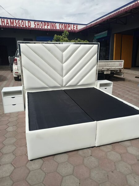 white bed with carved headboard